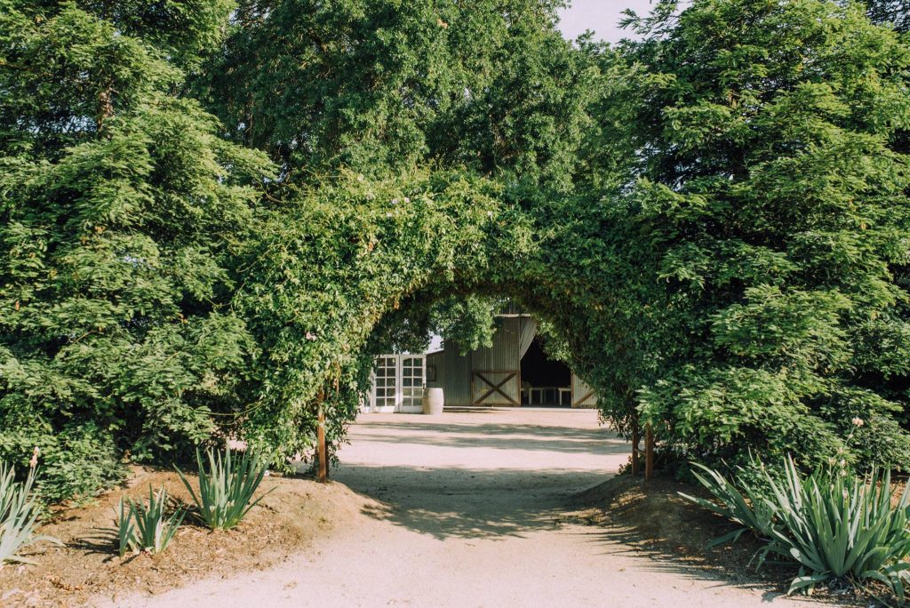 The Barn at Second Wind, Sacramento River Road, Country Farmland. Entry under vining archway.