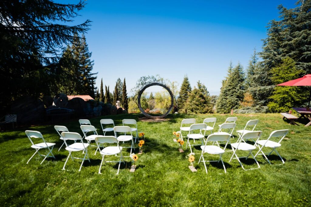 Chateau Daveall Boutique Winery. El Dorado County. Wedding on lawn with circular arch.